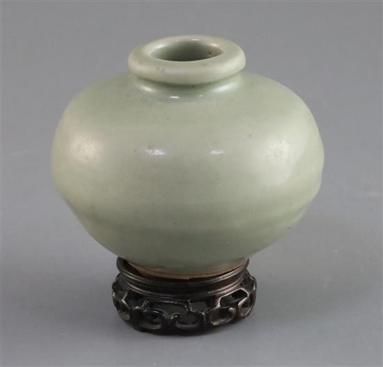 A Chinese Longquan celadon jarlet, Song dynasty, H. 7cm, wood stand